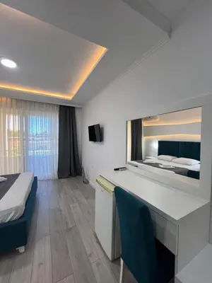 a hotel room with a bed and a desk at Apartments Fati & Flori in Ulcinj