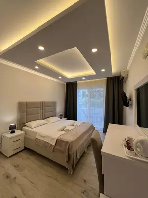 a bedroom with a bed and a large window at Apartments Fati & Flori in Ulcinj