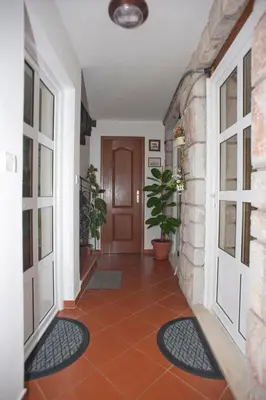 a hallway with a door and a tile floor at Apartments Marina in Sveti Stefan