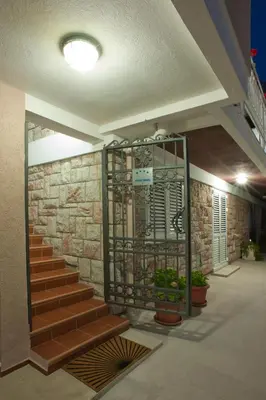a staircase in a building with a stone wall at Apartments Marina in Sveti Stefan