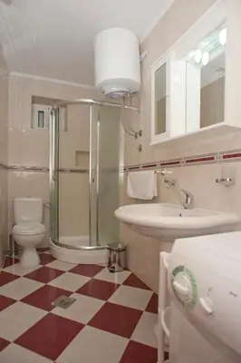 a bathroom with a toilet and a sink and a shower at Apartments Marina in Sveti Stefan