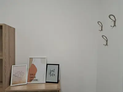 a shelf with three picture frames on a wall at Paun apartment in Kotor