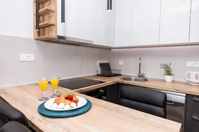 a kitchen with a table with a plate of food on it at Paun apartment in Kotor