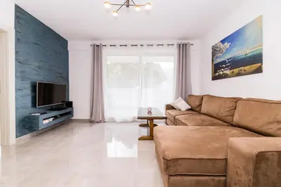 a living room with a couch and a tv at Paun apartment in Kotor