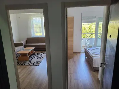 a view of a living room with a couch and a room with a living room at Dina & Dona in Ulcinj