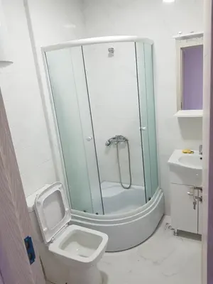 a bathroom with a shower and a toilet and a sink at Dina & Dona in Ulcinj