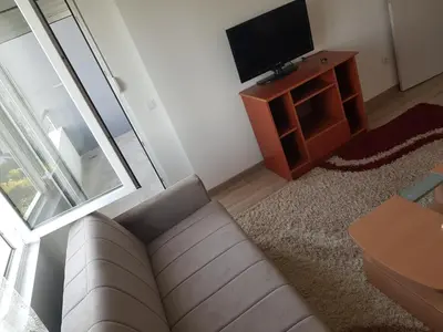 a living room with a couch and a tv at Dina & Dona in Ulcinj