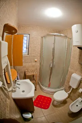 a bathroom with a shower and a toilet and a sink at Apartments Mandarina Garden in Petrovac na Moru