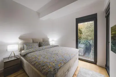 a bedroom with a large bed and a window at ZAFIRO SPA & RESIDENCE in Budva