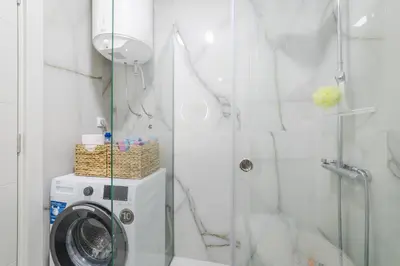 a bathroom with a washing machine and a shower at ZAFIRO SPA & RESIDENCE in Budva