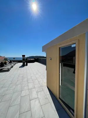a building with a large glass door on a roof at ZAFIRO SPA & RESIDENCE in Budva