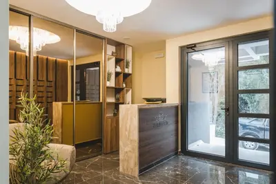 a lobby with a glass door and a table at ZAFIRO SPA & RESIDENCE in Budva