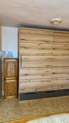a large wooden wall in a room at Apartmani Green Olive in Bar, Susanj