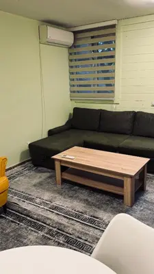 a living room with a couch and a coffee table at Apartmani Green Olive in Bar, Susanj