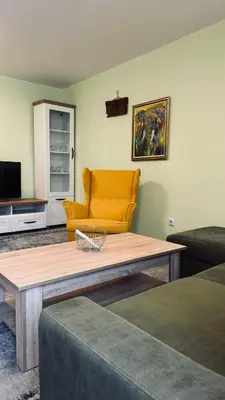 a living room with a couch and a coffee table at Apartmani Green Olive in Bar, Susanj
