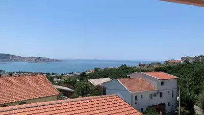 a view of a town with red roofs and the ocean at Apartmani Green Olive in Bar, Susanj