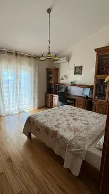 a bedroom with a bed and a desk in it at Villa Green Olive Bar in Bar, Susanj