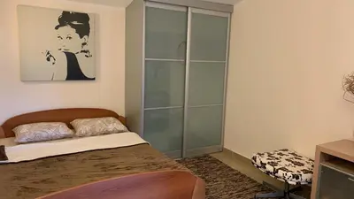 a bedroom with a bed and a glass cabinet at Villa Green Olive Bar in Bar, Susanj