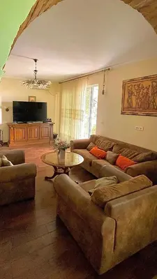 a living room with two couches and a table at Villa Green Olive Bar in Bar, Susanj