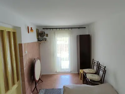 a living room with a mirror and a table and chairs at Apartman Sole in Sutomore