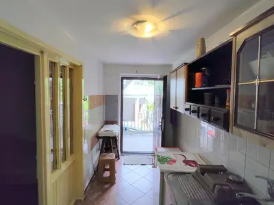a kitchen with a sink and a stove at Apartman Sole in Sutomore