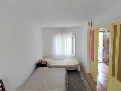 a small room with two beds and a window at Apartman Sole in Sutomore