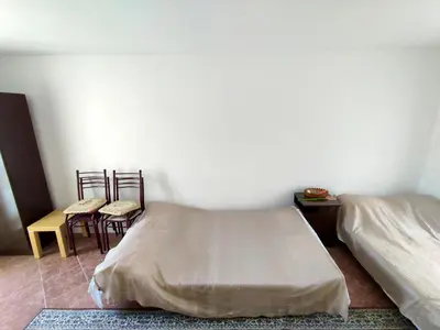 a bedroom with two beds and a table and chairs at Apartman Sole in Sutomore