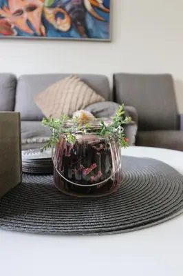a table with a glass bowl with plants on it at Apartment Sandrita in Kotor