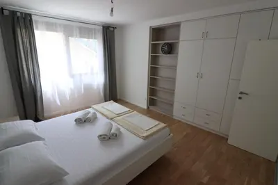 a bedroom with a bed with towels and a window at Apartment Sandrita in Kotor