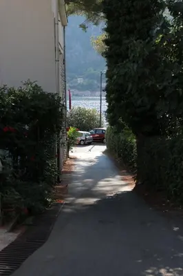 a road with cars parked on the side of a building at Apartment Sandrita in Kotor