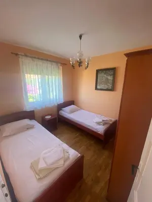 a bedroom with two beds and a chandelier at Apartman Elena in Ulcinj