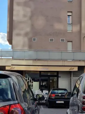 a parking lot with cars parked in front of a store at City kvart apartman in Podgorica