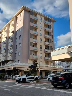 a large building with cars parked in front of it at City kvart apartman in Podgorica