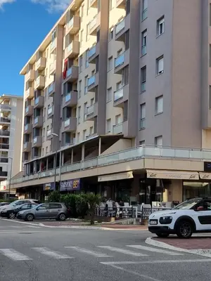 a large building with cars parked in front of it at City kvart apartman in Podgorica