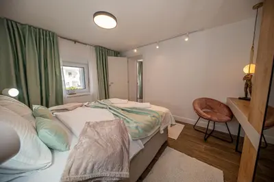 a bedroom with a bed and a desk and a chair at N&N Lux Guest house in Bar
