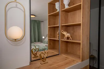 a room with a wooden shelf with a mirror at N&N Lux Guest house in Bar