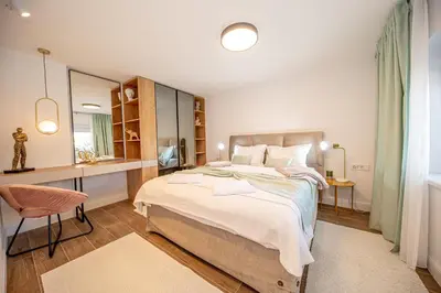 a bedroom with a large bed and a desk at N&N Lux Guest house in Bar