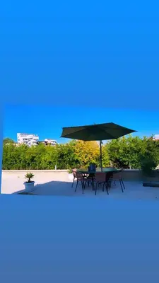 a table with an umbrella on top of a building at Keno & Keon in Ulcinj