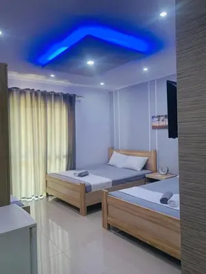 two beds in a room with a blue ceiling at Keno & Keon in Ulcinj