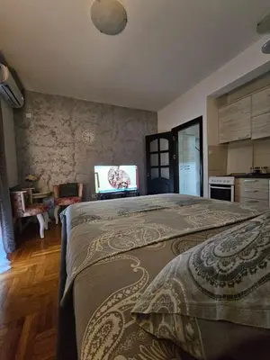a bedroom with a bed with a laptop on it at Studio Place 8 in Podgorica