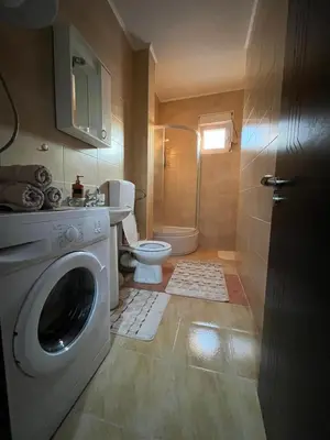 a bathroom with a washing machine and a toilet at Studio Place 8 in Podgorica