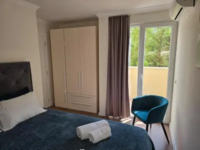 a bedroom with a bed and a chair and a window at Vila Federica in Bar