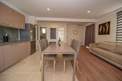 a kitchen and living room with a table and chairs at Vila Federica in Bar