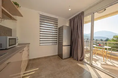a kitchen with a stainless steel refrigerator and a balcony at Vila Federica in Bar