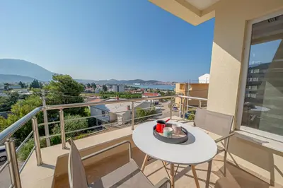 a balcony with a white table and chairs at Vila Federica in Bar