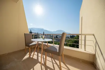 a balcony with a table and two chairs and a window at Vila Federica in Bar