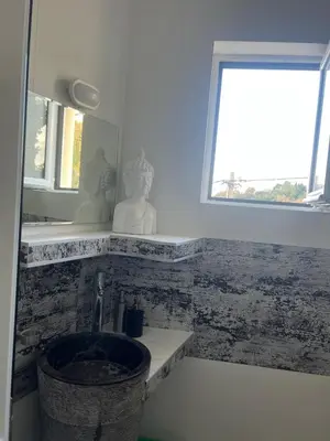 a bathroom with a sink and a window at Mahakala Center in Petrovac na Moru