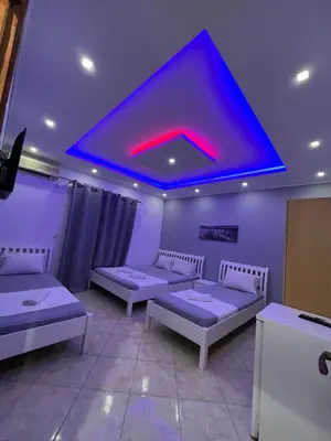 a room with three beds and a blue ceiling at Keno & Keon in Ulcinj