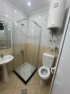 a bathroom with a shower and a toilet and a sink at Keno & Keon in Ulcinj