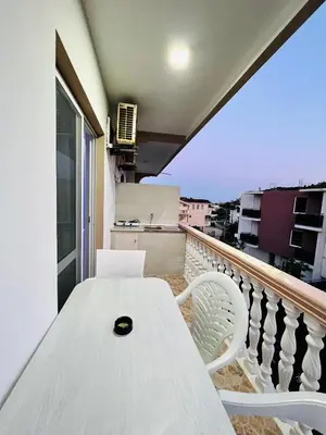 a white table and chairs on a balcony at Keno & Keon in Ulcinj